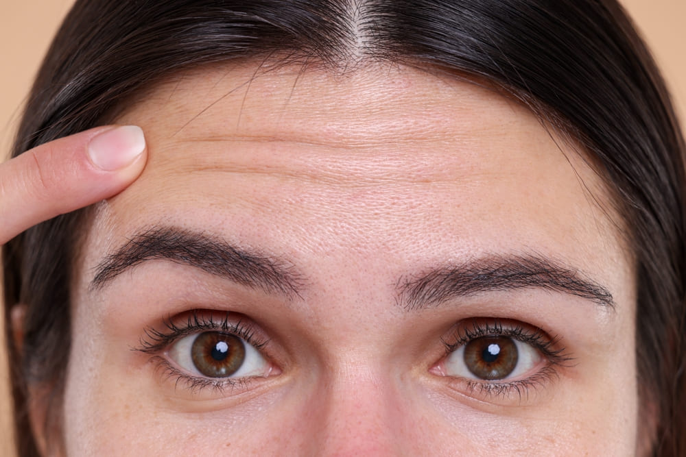 Close-up view of a woman with wrinkles on her forehead