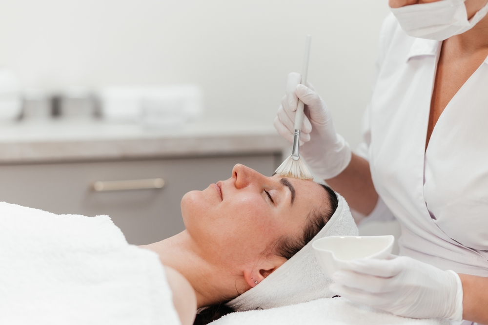 Lady receiving rejuvenation anti aging treatment, facial chemical peel therapy